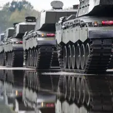 Army people standing and seeing army helicopter