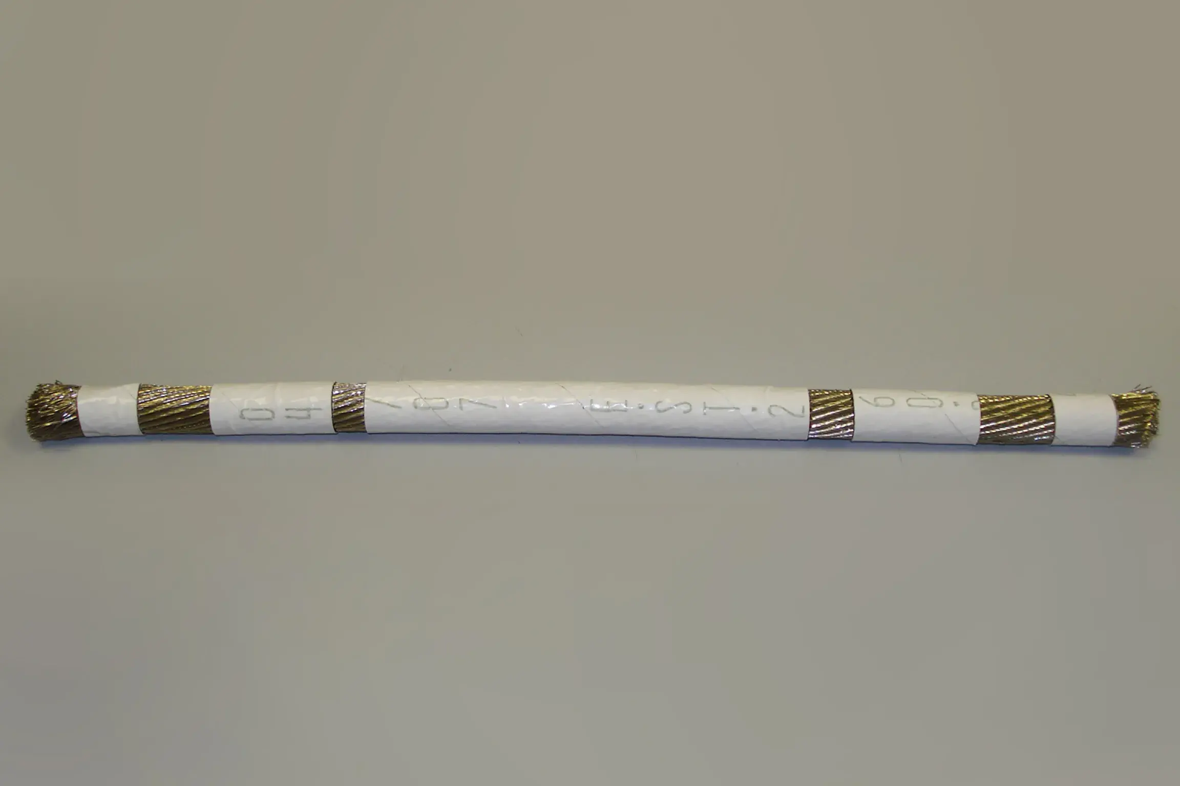 04/07 EST 2 60 White colored wrapper for golden wire.